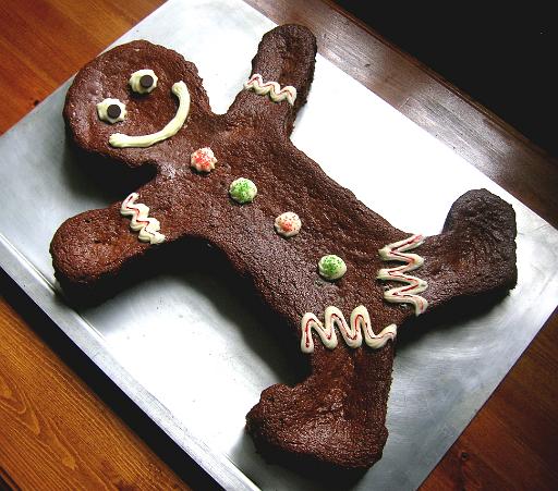 gingerbread_man_cake_final1.jpg - This is an easy but special cake for the holidays. Spice up some yellow cake mix with our Gingerbread Cake recipe. Use a Cake-Shaping Strip to make a cake in the shape of the classic gingerbread man. Then pipe on some decorations (using out Orange Cream-Cheese Frosting recipe). On our blog page, find and click on this image in the pictorial index for more details.